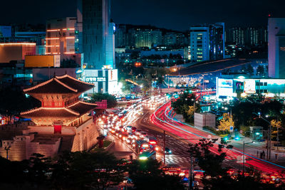 High angle view of illuminated city street and buildings at night