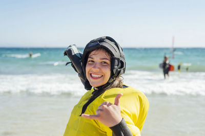 Smiling woman gesturing during training at beach