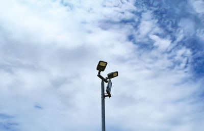 Low angle view of electrical equipment against sky