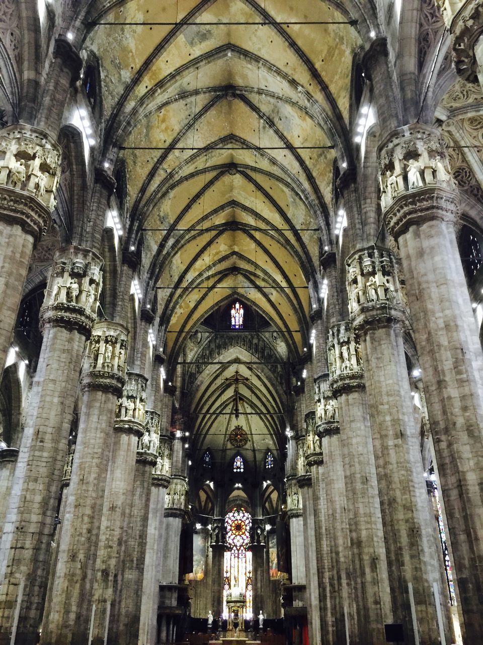 indoors, religion, place of worship, spirituality, arch, ceiling, architecture, church, built structure, cathedral, low angle view, interior, architectural feature, arcade, history, travel destinations, famous place, international landmark, tourism, ancient civilization, architectural column, culture, diminishing perspective, pew, capital cities, day, duomo di milano