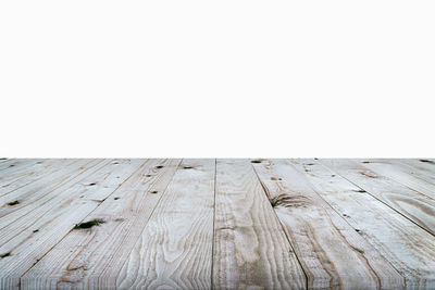 Close-up of wooden table against white background