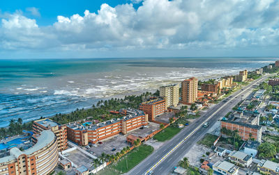 High angle view of townscape by sea against sky