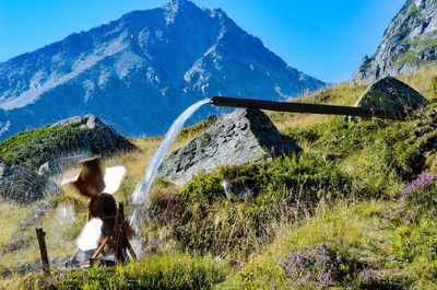 Full length of man climbing on mountain against sky