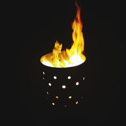 Close-up of burning fire against black background