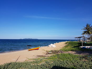 Scenic view of beach against blue sky