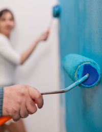 Close-up of man working on wall