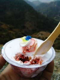 Close-up of hand holding ice cream