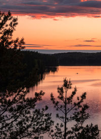 Scenic view of lake against romantic sky at sunset