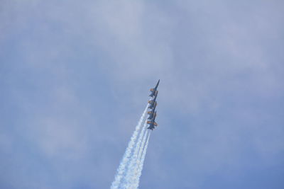 Low angle view of airplane flying against sky