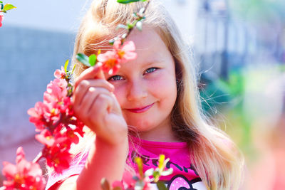 Portrait of cute girl holding flowers