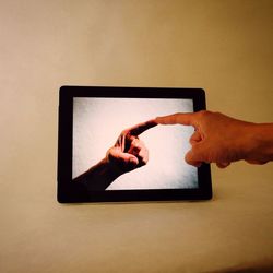 Human hand touching digital tablet