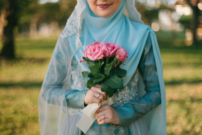 Close-up of man holding bouquet