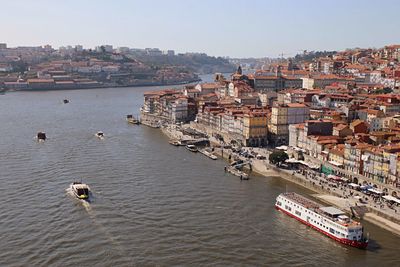 High angle view of river and townscape against sky