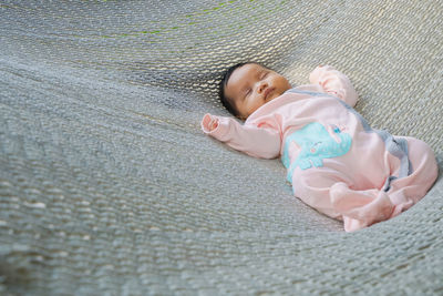 High angle view of baby sleeping in hammock