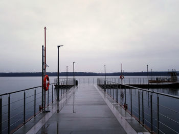 Pier on sea against sky during sunset