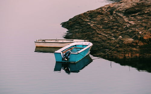 Boat moored on sea against clear sky