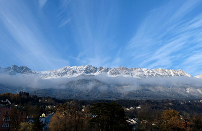 Clouds and blue sky behind snowy mountain peak the nordkette, innsbruck, tyrol austria. 