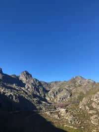 Scenic view of mountains against clear blue sky