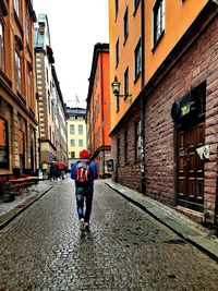 Rear view of man walking on street