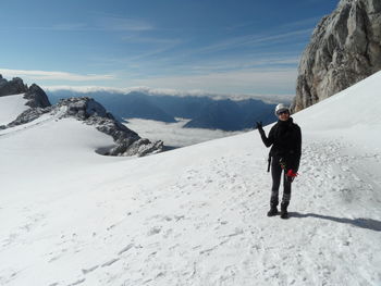 Full length of man on snowcapped mountains against sky