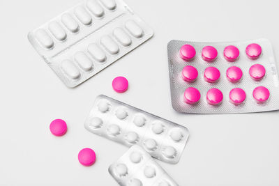 High angle view of pink petals on white background