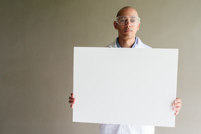 Low angle view of man standing against wall