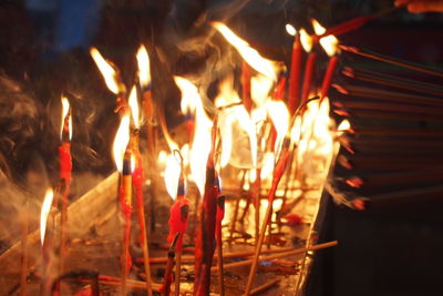 Close-up of lit candles at night