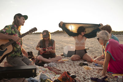 Group of hipsters enjoying on beach