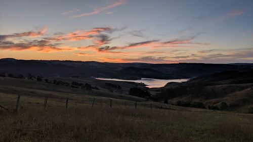 Scenic view of field against sky during sunset