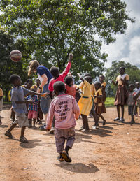 Group of children playing with people in background