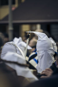 Close-up of man holding white flowers