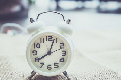 Close-up of alarm clock on table