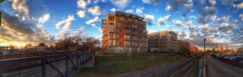 View of buildings against cloudy sky at sunset