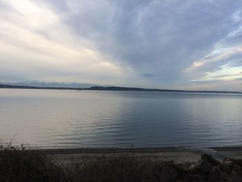 Scenic view of sea against cloudy sky