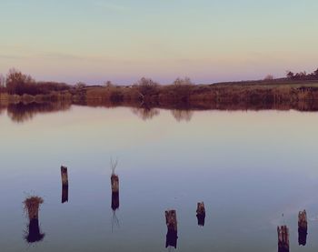 Scenic view of lake against sky during sunset