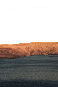 Scenic view of desert against clear sky