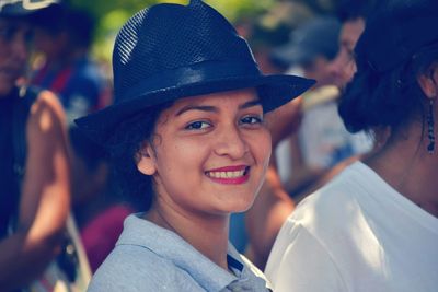 Portrait of a smiling young woman wearing hat