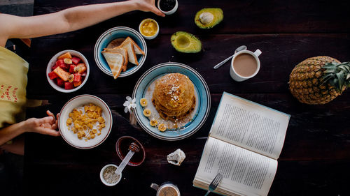 Directly above shot of woman with breakfast on table