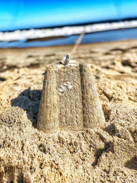 Surface level of sand on beach against sky