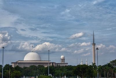 Mosque against sky in city