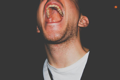 Close-up of man against black background