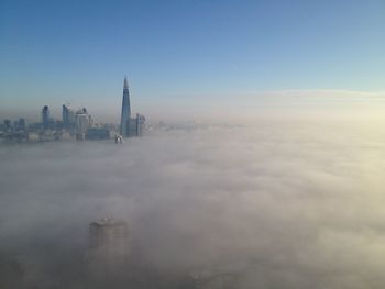 Modern buildings in foggy weather at dusk