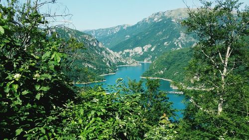 Scenic view of lake with mountains in background