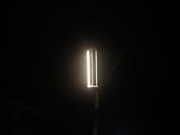 Low angle view of illuminated light bulb on street