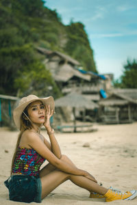 Portrait of happy girl on sand at beach