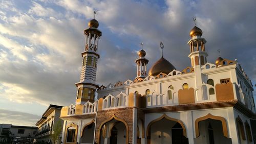Low angle view of cathedral against cloudy sky