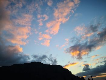 Low angle view of silhouette mountain against dramatic sky