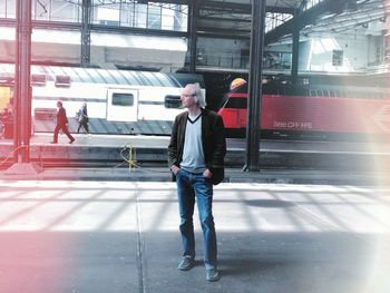 Man standing on railroad station platform