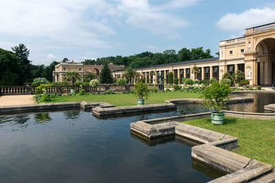 View of swimming pool by building against sky