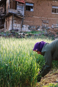 Side view of man relaxing on field